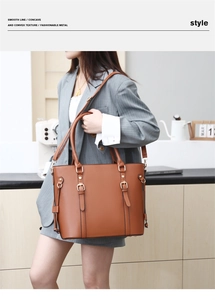 Brown leather tote bag with gold buckle detail shown on grey blazer outfit