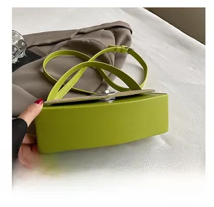 Detailed macro view of the lime green handbag durable bottom and smooth leather finish