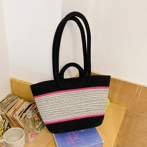 Large woven beach tote bag with black, white, and pink horizontal stripes and dual handles