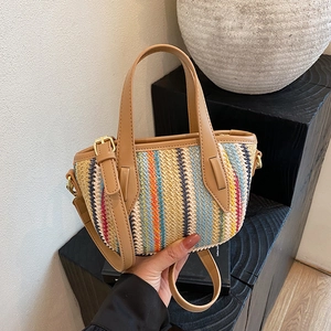 Chic multi-color striped woven beach bag with tan leather handles and adjustable strap