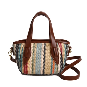 Colorful striped woven tote bag with brown leather handles and a removable shoulder strap