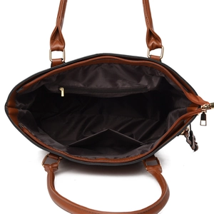 Interior detail of large brown tote bag showing fabric lining and zipper pockets