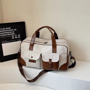 Canvas travel duffel bag with leather straps and contrast stitching for sports and gym