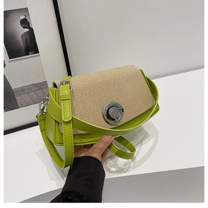 Detail of straw patchwork bag with green leather trim and silver ring buckle