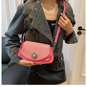 Detail of pink PU leather crossbody bag with woven texture lid and silver round lock