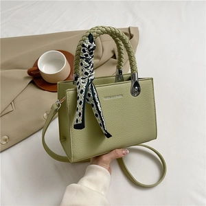 Sage green lychee leather handbag with woven handle and plaid silk scarf decoration