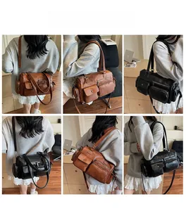 Détail de sacs fourre-tout en cuir à plusieurs poches avec fermetures éclair métalliques