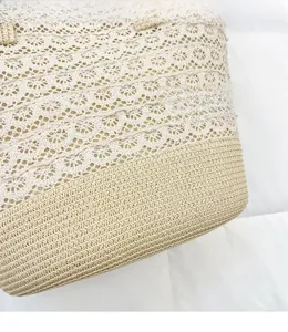 Detail of bohemian straw tote bag showing intricate crochet lace and woven textures