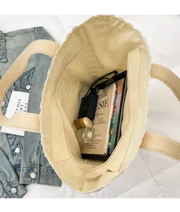 Top view of cream woven tote bag interior showing large capacity and zipper pocket