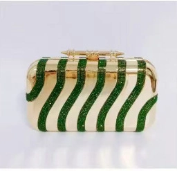 Detailed view of vintage gold evening bag with green rhinestone wavy textured stripes