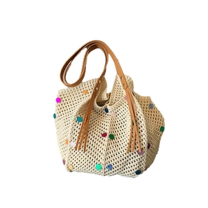 Straw tote bag with colorful sequins and brown leather straps for summer beach vacation