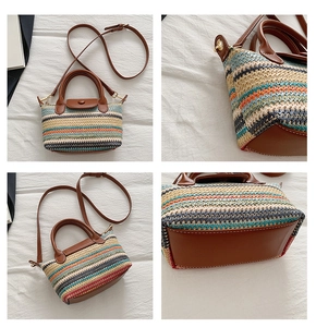 Detail view of multi-color woven straw bag with brown leather trim and gold hardware