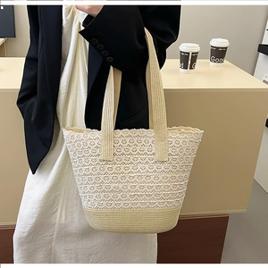 Detail of cream lace woven tote bag with wide strap in a cozy lifestyle setting