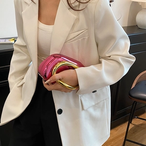 Detail of a metallic pink evening bag with a bold gold circular metal handle