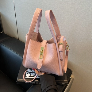 Pink lychee grain leather bucket handbag with gold twist lock and adjustable strap