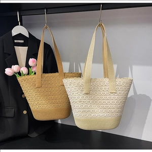 Close-up of woven bucket bags featuring intricate lace hollow patterns and sturdy handles
