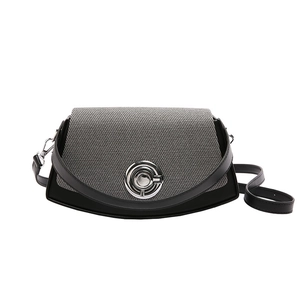 Modern grey and black contrast shoulder bag with silver clasp and woven texture