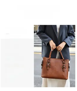 Détail d'un grand sac cabas marron vintage avec boucles métalliques en situation