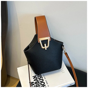 Detail of the litchi pattern faux leather texture on black and brown bucket bag