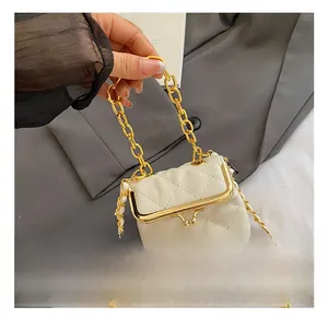 Detailed shot of white quilted leather mini bag with gold chain and metal clasp