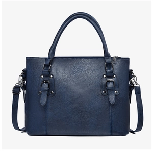 Détails du sac à main bleu marine en cuir grainé avec rivets et bandoulière