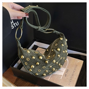 Close-up of moss green suede dumpling bag with golden rivets and metallic eyelets