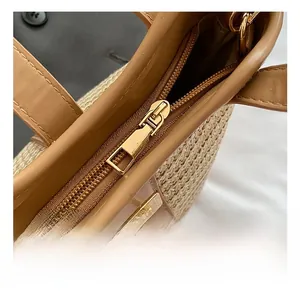 Detail view of smooth zipper and golden hardware on woven bucket tote bag