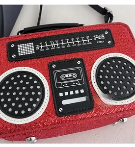 Macro shot of red sequin radio-shaped bag detailing FM/AM dial and texture