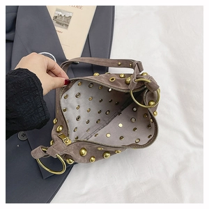 Close-up of the spacious interior with zipper closure and gold stud details on the handbag