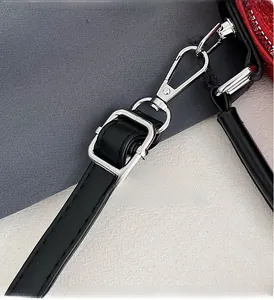 Macro detail of high-gloss silver metal adjustable buckle on a black leather strap