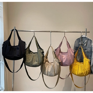 Five colors of nylon tote bags with pleated texture and adjustable straps on display