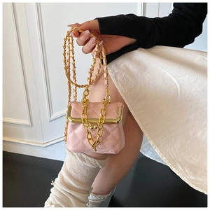 Detailed close-up of pink quilted mini bag with gold chain strap and metal frame clasp