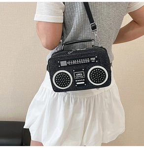 Detail of creative vintage radio crossbody bag with sparkling sequins and silver hardware