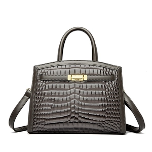 Dark grey crocodile embossed leather handbag with gold metallic clasp and top handle