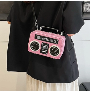 Detailed view of creative retro radio-shaped crossbody bag with pink glitter finish