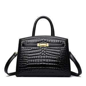 Elegant black crocodile pattern handbag with gold hardware and detachable shoulder strap