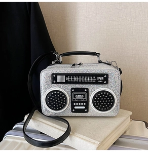 Macro detail of silver sequin retro radio bag with vintage frequency dial and zip closure