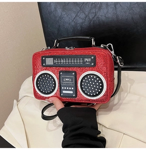 Detailed view of retro radio-shaped bag with red sequins and analog dial design