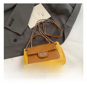 Detail of contrast color chain bag with quilted stitching and metallic twist lock