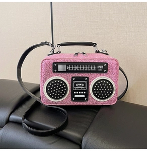 Macro shot of creative pink sequin radio bag showing vintage dial and glitter texture