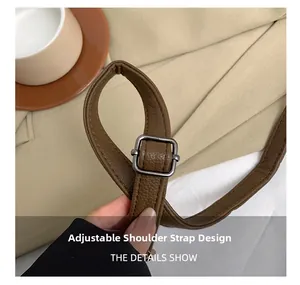 Close-up of brown leather adjustable shoulder strap with vintage silver metal buckle detail