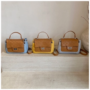 Three quilted leather flap handbags in blue denim, yellow, and grey fabric on stone steps