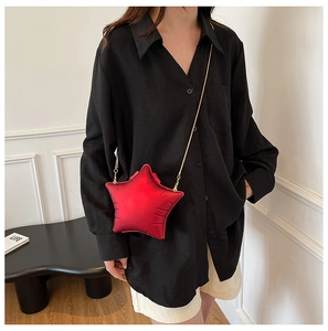 Star-shaped red crossbody bag with elegant gold chain strap and velvet texture detail