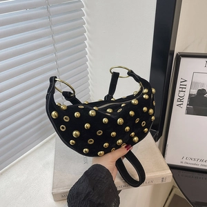Black suede crescent handbag with gold studs and dual ring handles in chic punk style