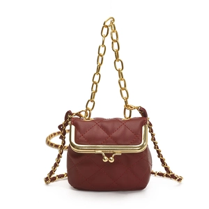 Deep red quilted mini handbag with classic diamond pattern and gold chain strap on white background