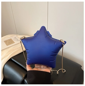 Detailed view of the star-shaped crossbody bag with soft matte blue finish and gold chain