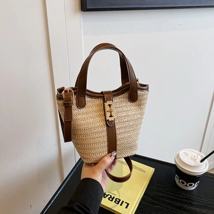 Fashionable woven bucket bag with brown leather trim and golden buckle closure