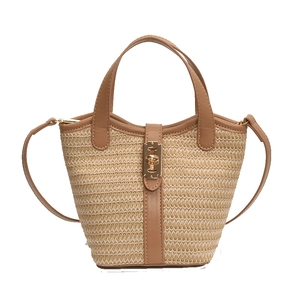 Fashionable beige woven bucket bag with brown leather trim and gold metal lock