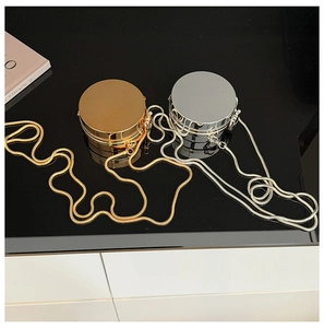 Minimalist round metallic mini bags in gold and silver with elegant snake chains