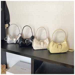 Row of minimalist half-moon bags in silver, black, white, and yellow with metal buckles